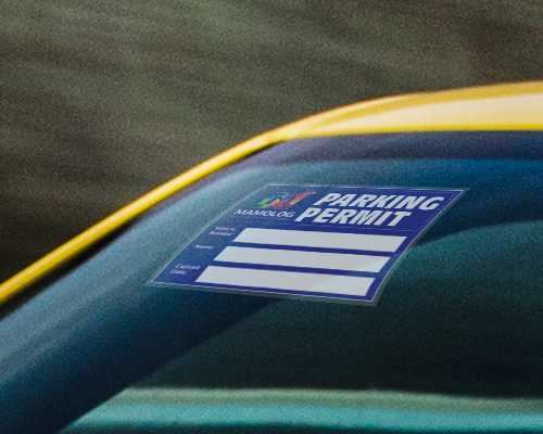 A static cling window sticker is placed on the car window, printed with a design in blue stating parking permit.