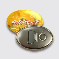 A oval shape button badge with orange juice advertisement and bottle opener structure.