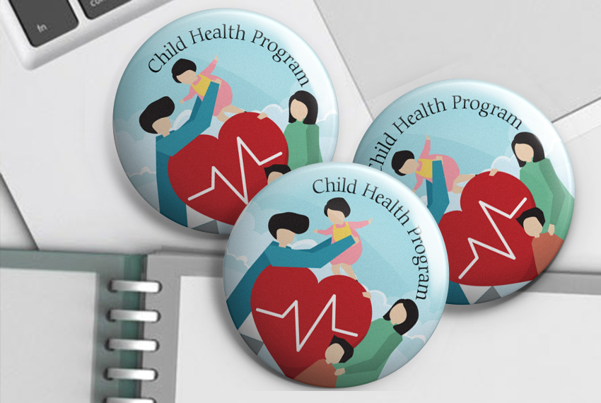 A button badge of a family gather around a red heart in a flat stylized design, labelled “Child Health Programme”.