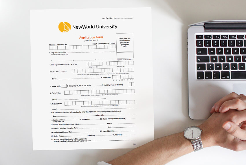 A blank application form to NewWorld University sits next to a laptop.