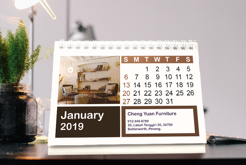 A simple soft stand desk calendar featuring the image of a beige living room, placed on a table.
