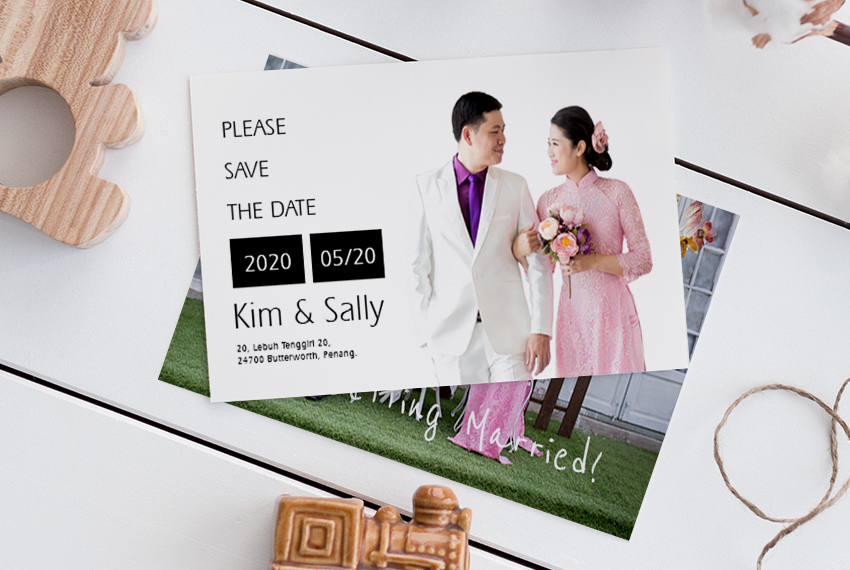 An invitation to a wedding sits on top of what appears to be a photograph of the same couple, but the photo underneath is mostly obscured.