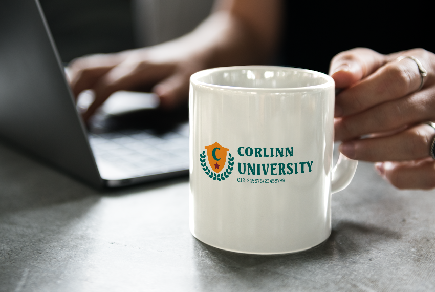 A hand holds onto a white mug printed with the text “Corlinn University”.