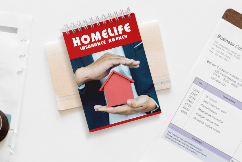 A wirebound notebook printed with “Homelife Insurance Agency” featuring a picture of a man holding a little house in his hands is placed next to other assorted paperwork.