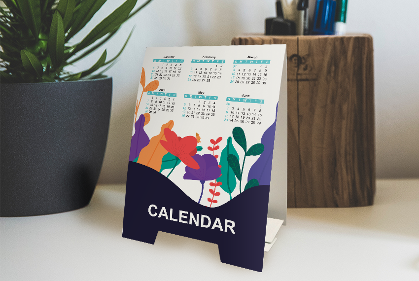 A tent card featuring a calendar, resting on a tabletop.