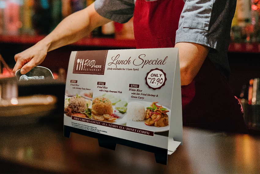 A tent card on a bar top featuring a lunch special promotion.