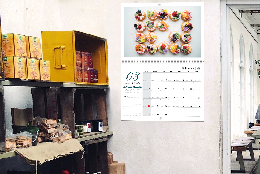A wire-O bound wall calendar featuring an assortment of fruit tarts.