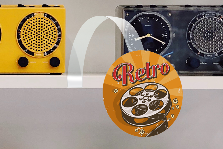 A card wobbler hangs from a shelf holding speakers, “Retro” is printed on the card.